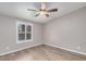 Bright bedroom with wood-look floors and window shutters at 1502 E Angela Dr, Phoenix, AZ 85022