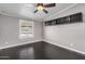 Bedroom with ceiling fan and dark wood flooring at 1502 E Angela Dr, Phoenix, AZ 85022