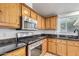 Kitchen features stainless steel appliances and wood cabinets at 1502 E Angela Dr, Phoenix, AZ 85022