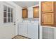 Laundry room with washer, dryer, cabinets, and exterior access at 1502 E Angela Dr, Phoenix, AZ 85022