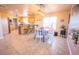 Kitchen dining area with tile floor and a farmhouse table at 15021 N 19Th Way, Phoenix, AZ 85022