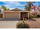 House exterior featuring a two-car garage and neat landscaping at 1511 W El Monte Pl, Chandler, AZ 85224