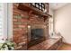 Brick fireplace with brass screen and mantel at 1511 W El Monte Pl, Chandler, AZ 85224