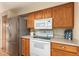 White appliances and wood cabinets in kitchen at 1511 W El Monte Pl, Chandler, AZ 85224