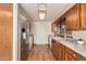 Kitchen with stainless steel appliances and wood cabinets at 1511 W El Monte Pl, Chandler, AZ 85224