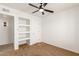 Bedroom with built-in shelving and ceiling fan at 1527 W Rosemonte Dr, Phoenix, AZ 85027