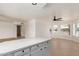 Open concept kitchen with white cabinets and breakfast bar at 1527 W Rosemonte Dr, Phoenix, AZ 85027