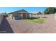 Spacious backyard with hot tub and covered patio at 15350 W Mauna Loa Ln, Surprise, AZ 85379