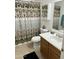 Clean bathroom includes a shower/tub, vanity, and decorative curtain at 15350 W Mauna Loa Ln, Surprise, AZ 85379