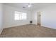 Bright bedroom with carpeted floors and a large closet at 15350 W Mauna Loa Ln, Surprise, AZ 85379