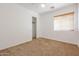 Well-lit bedroom featuring a ceiling fan and ample closet space at 15350 W Mauna Loa Ln, Surprise, AZ 85379