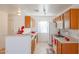 Bright kitchen with wood cabinets and white appliances at 15350 W Mauna Loa Ln, Surprise, AZ 85379