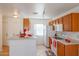 Bright kitchen with wood cabinets and white appliances at 15350 W Mauna Loa Ln, Surprise, AZ 85379