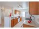 Bright kitchen with wood cabinets and white appliances at 15350 W Mauna Loa Ln, Surprise, AZ 85379