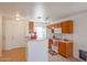 Bright kitchen with wood cabinets and white appliances at 15350 W Mauna Loa Ln, Surprise, AZ 85379