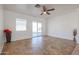 Living room with tile floors, ceiling fan and backyard access at 15350 W Mauna Loa Ln, Surprise, AZ 85379