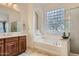 Elegant bathroom with soaking tub and double vanity at 15526 W Minnezona Ave, Goodyear, AZ 85395