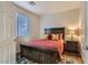 Cozy bedroom with rustic wood bed frame and nightstand at 15526 W Minnezona Ave, Goodyear, AZ 85395