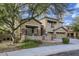 Two-story house with stone accents, landscaping, and a three-car garage at 15526 W Minnezona Ave, Goodyear, AZ 85395