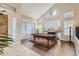 Living room with a pool table and hardwood floors at 15526 W Minnezona Ave, Goodyear, AZ 85395