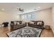 Cozy living room with two sofas, area rug, and wood flooring at 15526 W Minnezona Ave, Goodyear, AZ 85395