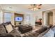 Spacious living room with sectional sofa, fireplace, and wood accent wall at 15526 W Minnezona Ave, Goodyear, AZ 85395