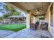 Relaxing covered patio with seating area and putting green at 15526 W Minnezona Ave, Goodyear, AZ 85395