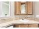 Small bathroom with corner sink and wood cabinets at 17200 W Bell Rd # 899, Surprise, AZ 85374