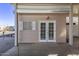 French doors leading to a backyard patio with covered exterior at 17200 W Bell Rd # 899, Surprise, AZ 85374