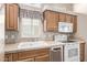 White appliances and wood cabinets in this well-lit kitchen at 17200 W Bell Rd # 899, Surprise, AZ 85374