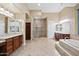 Luxurious bathroom featuring a large shower, double vanity, and a soaking tub at 1731 W Steinway Dr, Phoenix, AZ 85041