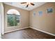 Bedroom with wood-look tile flooring and an arched window at 1731 W Steinway Dr, Phoenix, AZ 85041