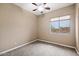 Bright bedroom with ceiling fan and large window offering natural light at 1731 W Steinway Dr, Phoenix, AZ 85041