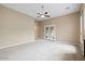 Open living room with neutral colors and French doors at 1731 W Steinway Dr, Phoenix, AZ 85041