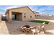 Backyard view showing patio, fire pit, and artificial turf at 17662 W Daley Ln, Surprise, AZ 85387