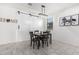 Dining area with sliding barn door and modern lighting at 17662 W Daley Ln, Surprise, AZ 85387