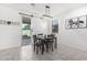 Dining area with sliding barn door and backyard view at 17662 W Daley Ln, Surprise, AZ 85387