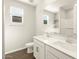 Elegant bathroom with double vanities, sleek white countertops, and modern fixtures, providing a luxurious feel at 17755 W Elm St, Goodyear, AZ 85395