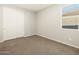 Bedroom featuring sliding door closet and carpeted floor at 17755 W Elm St, Goodyear, AZ 85395