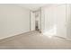 Well-lit bedroom with a spacious closet, neutral carpet, and light gray walls, creating a cozy and inviting atmosphere at 17755 W Elm St, Goodyear, AZ 85395