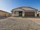 Attractive single-story home with a neutral color scheme and drought-tolerant landscaping at 17755 W Elm St, Goodyear, AZ 85395