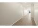 Bright hallway featuring tile floors and neutral walls providing access to various rooms at 17755 W Elm St, Goodyear, AZ 85395