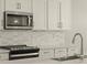 Close up of kitchen featuring stainless steel microwave and oven with white cabinets at 17755 W Elm St, Goodyear, AZ 85395