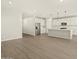 Bright kitchen featuring modern appliances, white cabinets, and a center island, flowing into the living space at 17755 W Elm St, Goodyear, AZ 85395