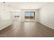 Open-concept living area with tile flooring leading to a modern kitchen and outdoor patio at 17755 W Elm St, Goodyear, AZ 85395