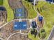 Aerial view of sports courts and playground with blue surfacing amid desert landscaping in a new residential community at 17755 W Elm St, Goodyear, AZ 85395