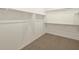 Walk-in closet featuring hanging racks and carpeted floor at 17755 W Elm St, Goodyear, AZ 85395