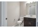 Modern bathroom with dark vanity, white countertop, and toilet at 18104 W Silverwood Dr, Goodyear, AZ 85338