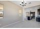 Bright dining room with view into kitchen and modern chandelier at 18104 W Silverwood Dr, Goodyear, AZ 85338