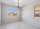 Light-filled dining room with tile flooring and a chandelier at 18104 W Silverwood Dr, Goodyear, AZ 85338